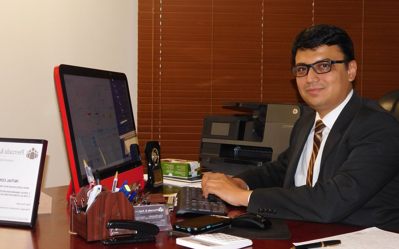 Irfan Peerzada, Principal Solicitor, at his desk in the Auburn office