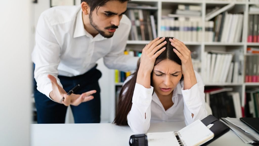 A manager shouting at a distressed employee