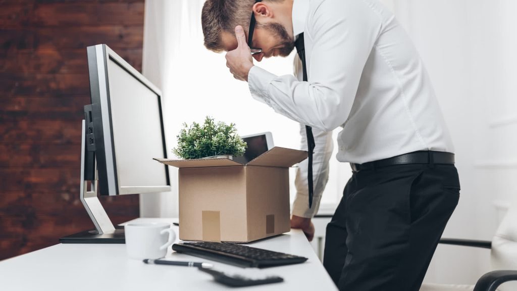 Employee packing up his desk after losing his job