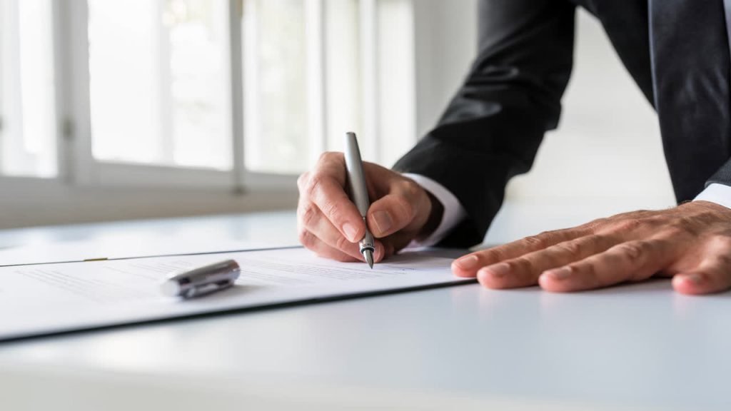 Business owner signing company documents