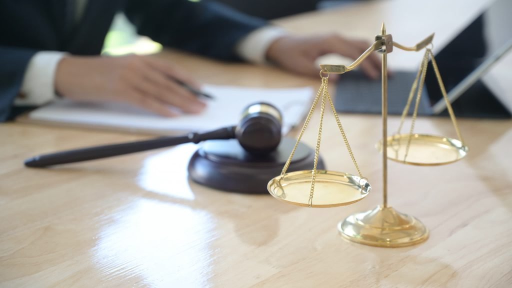 Lawyer at a desk with the scales of justice