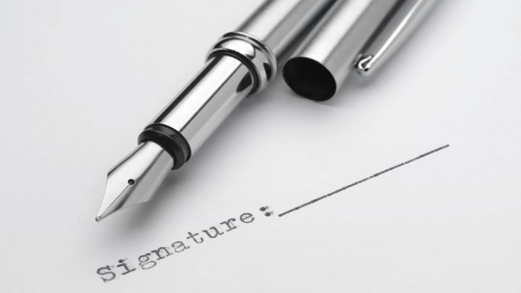 A fountain pen beside a signature line