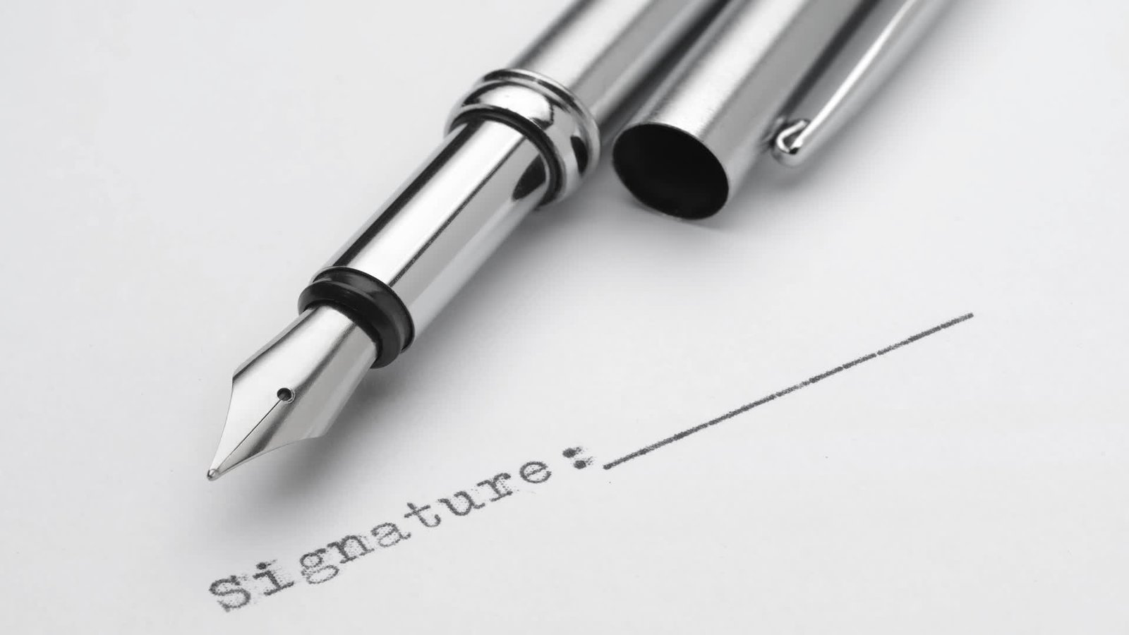Fountain pen above a signature line