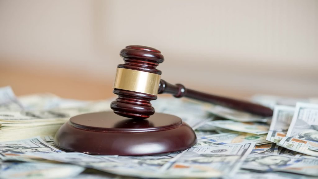 Judge’s gavel resting on banknotes