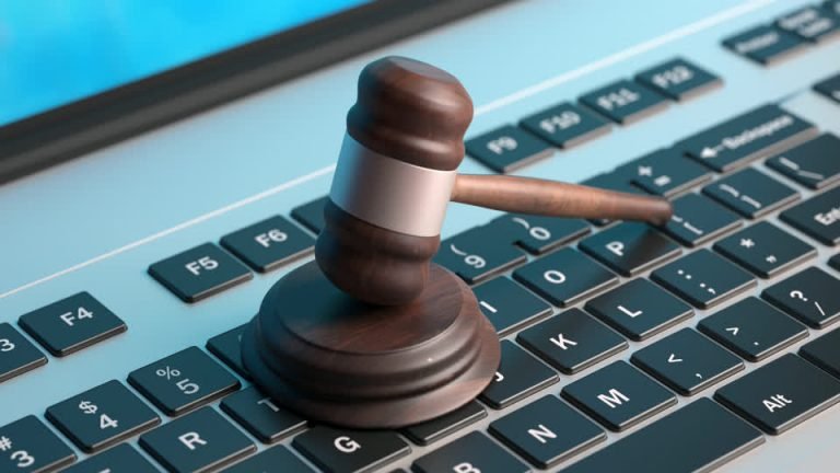 A gavel resting on a computer keyboard