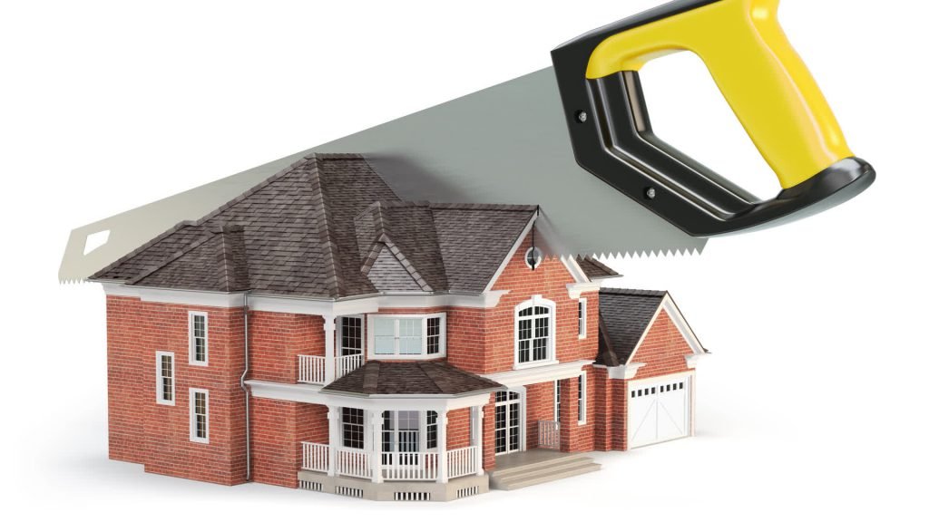 A saw cutting a model house in half